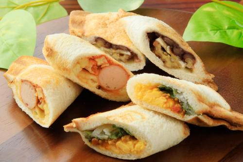 a group of sandwiches on a plate on a table at QuintessaHotel FukuokaHakata Relax&Sleep in Fukuoka