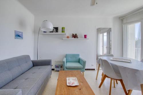 un salon avec un canapé et une table dans l'établissement Bright 60m near the beach, à Six-Fours-les-Plages
