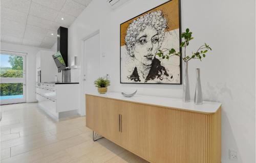 a kitchen with a large painting of a woman on the wall at Nice Home In Haderslev With 2 Bedrooms, Wifi And Outdoor Swimming Pool in Haderslev