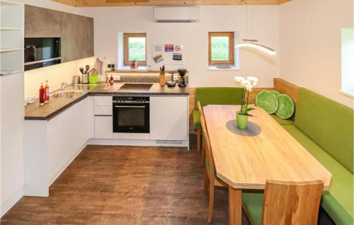 a kitchen with a wooden table and a green couch at Kellerstoeckl In Eltendorf in Eltendorf