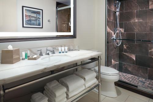 a bathroom with a sink and a toilet and a mirror at The Westin Poinsett, Greenville in Greenville