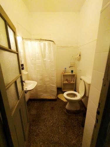 a bathroom with a toilet and a sink and a shower at La Casa de Lalo in Cafayate