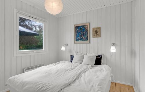 a white bedroom with a large bed and a window at 2 Bedroom Pet Friendly Home In Hornbk in Hornbæk