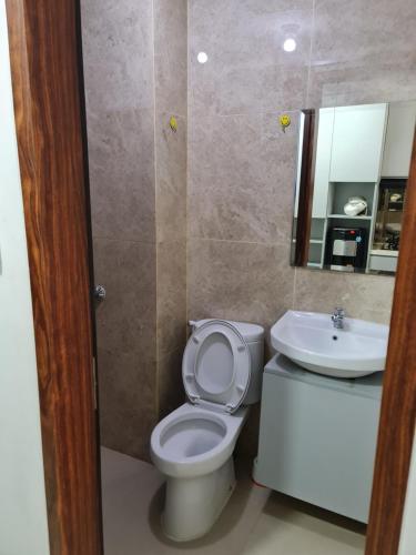 a bathroom with a toilet and a sink at Apartemen transpark cibubur by parvez 2 in Kalimanggis