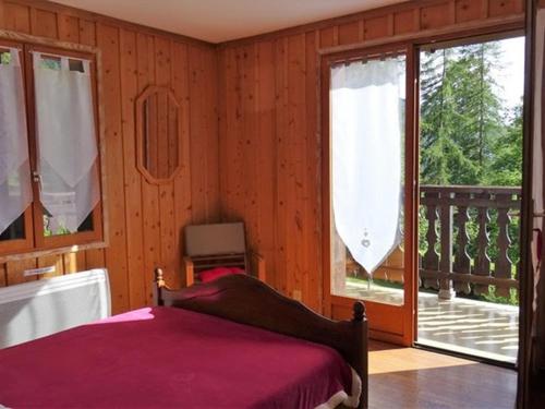 a bedroom with a bed and a balcony at Chalet Cohennoz, 4 pièces, 10 personnes - FR-1-733-29 in Cohennoz