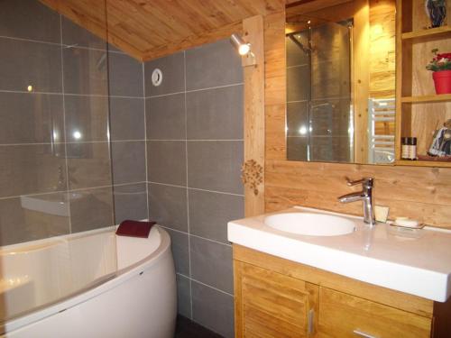 a bathroom with a tub and a sink and a bath tub at Chalet Crest-Voland, 6 pièces, 8 personnes - FR-1-733-37 in Crest-Voland