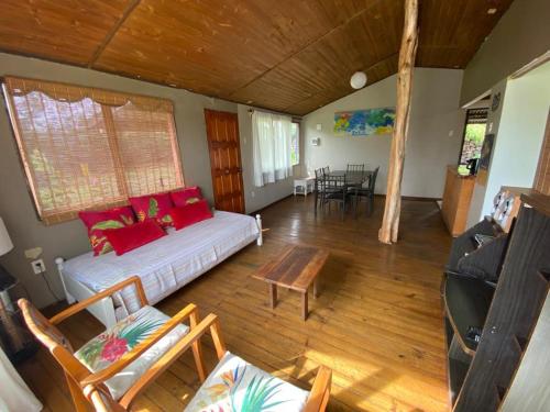a living room with a couch and a table at Casa familiar en sector residencial "HARE TOKE" in Hanga Roa