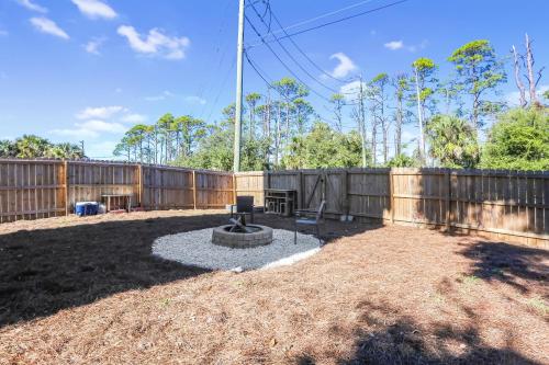 a backyard with a fence and a fountain at Eagle's Rest by Pristine Properties Vacation Rentals in Indian Pass