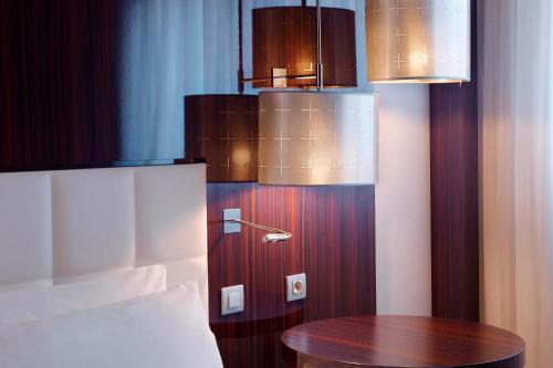 a room with a table and some lights at Le Méridien Paris Arc De Triomphe in Paris