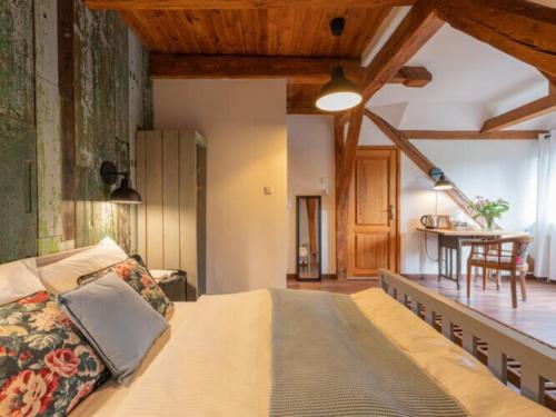 a bedroom with a large bed and a dining room at Villa in Be czna near Lake Kl pnicko in Bełzcna