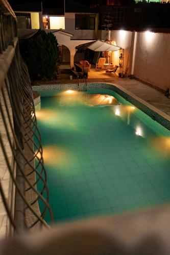 a swimming pool lit up at night at HOTEL AREQUIPA in Nazca
