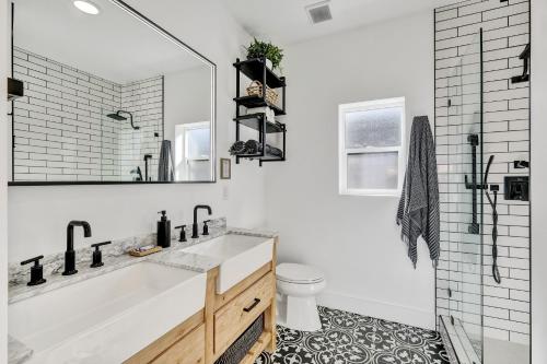 Un baño blanco con bañera y lavabo. en Newly Built Modern Home w Ocean View Rooftop Deck, en Avalon