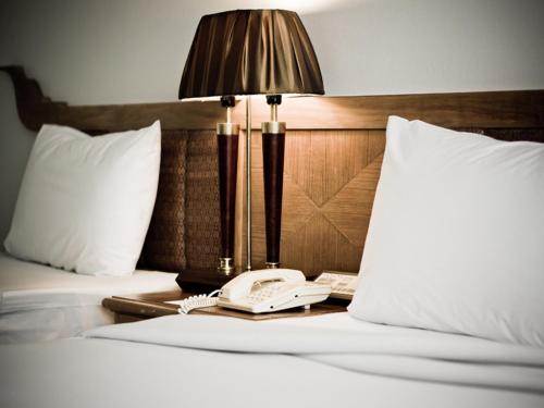 Postel nebo postele na pokoji v ubytování Laithong Hotel