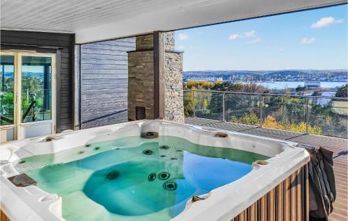 a hot tub on the balcony of a house at Nice Home In Sandefjord With Wifi in Sandefjord
