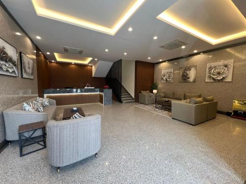 a lobby with couches and tables in a building at سمو سويت للشقق المخدومة 2 Smo Suites in Riyadh
