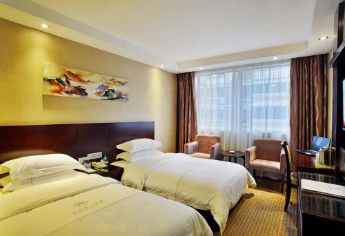 a hotel room with two beds and a window at Slowcom┃Yuebei Hotel （Guangzhou Provincial Government) in Guangzhou