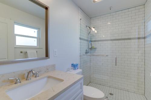 a bathroom with a sink and a toilet and a mirror at St Petersburg Vacation Rental 1 Mi to Downtown! in St Petersburg