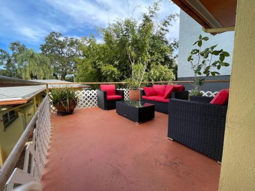 a patio with couches and chairs on a balcony at CLR St. Pete in St Petersburg