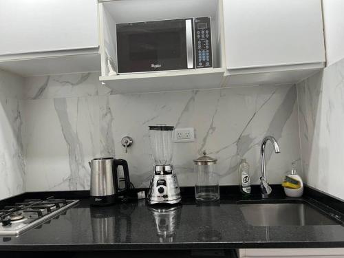 a kitchen counter with a blender and a microwave at Buenos Aires City in Buenos Aires
