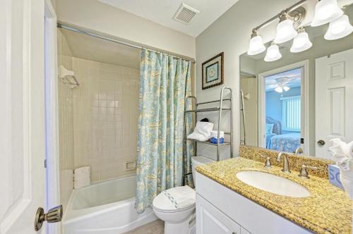 a bathroom with a sink and a toilet and a shower at Anna Maria Island Beach Sands 201 in Bradenton Beach