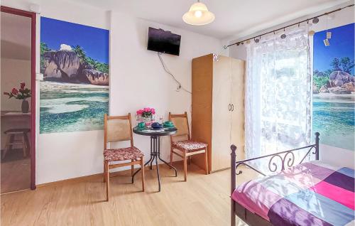 ein Schlafzimmer mit einem Tisch, Stühlen und einem Bett in der Unterkunft Amazing Home In Dzwirzyno With Wifi in Dźwirzyno