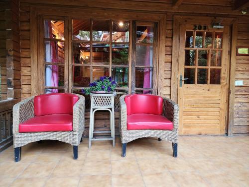 two chairs and a table on a porch at The Chalets Naldehra in Shimla