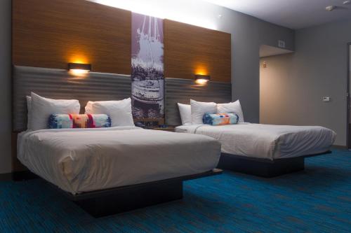 a hotel room with two beds in a room at Aloft Corpus Christi in Corpus Christi