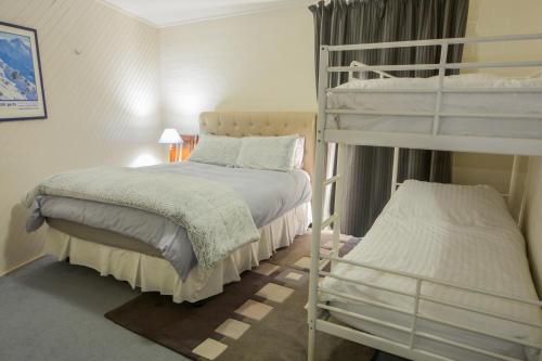 a bedroom with two bunk beds and a bed at Molony's 12 in Mount Buller