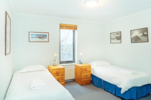 a bedroom with two beds and a window at Candoux 5 in Mount Buller