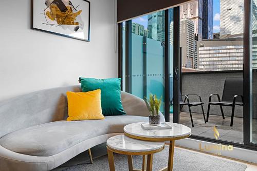 a living room with a couch and a table at Lumina Suites in Melbourne