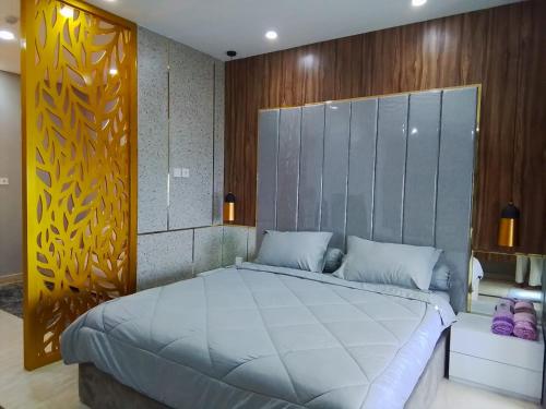 a bedroom with a large bed in a room at Apartment Medan Podomoro City Deli by OLS Studio in Medan