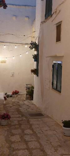 a white building with lights on the side of it at Dimora Lavinia Casa vacanze Centro storico Ostuni in Ostuni