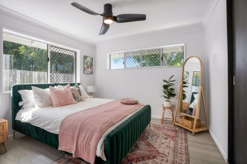a bedroom with a bed and a ceiling fan at Spindrift Unit 1 10 Spectrum Street Rainbow Beach in Rainbow Beach