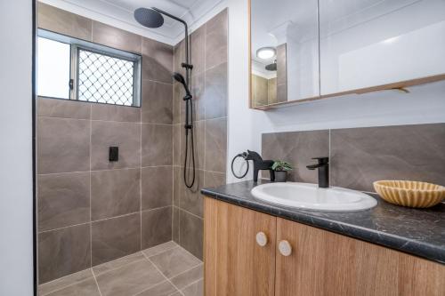 a bathroom with a sink and a shower at Spindrift Unit 1 10 Spectrum Street Rainbow Beach in Rainbow Beach