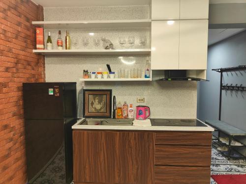 a kitchen with a black refrigerator and a counter at Boulevard Rollandes house in Hanoi