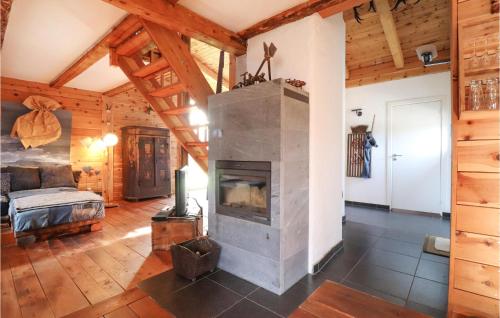 a living room with a fireplace in a log cabin at Nice Home In Mhldorf With 2 Bedrooms And Sauna in Mühldorf