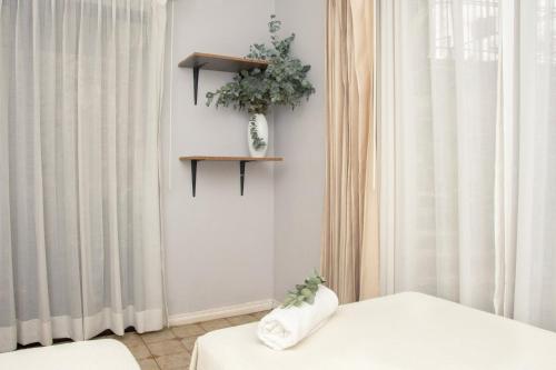 a room with a bed and a window with curtains at Casa Carmen in Santiago Este