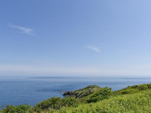 a view of the ocean from a hill at Headlands Hideaway in Coverack