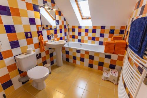 a bathroom with a toilet and a sink and a tub at Apartmánový dům Vilémovice in Vilémovice