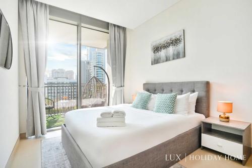 a bedroom with a large bed and a large window at LUX 52 42 Deluxe Marina view suite 1 in Dubai