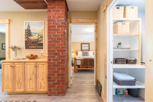 a room with a brick wall and a doorway at Craftsman's Loft - Heritage charm - AC - 5 min DT in Calgary