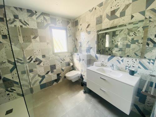 a bathroom with a toilet and a sink and a mirror at Capella Suttana in Ventiseri
