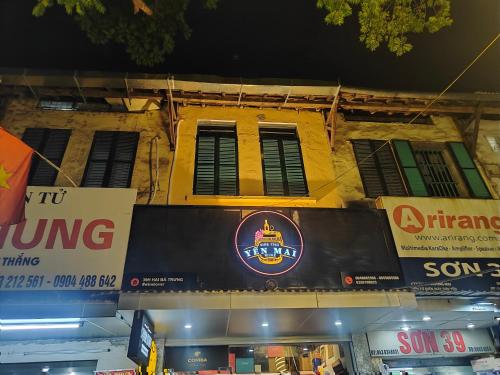 a building with a sign on the side of it at Boulevard Rollandes house in Hanoi