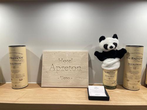 a panda bear sitting on a shelf with some products at Hotel Apreton in Tokyo