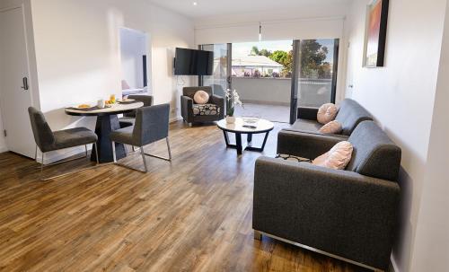 a living room with two couches and a table at Quattro On Young in Newcastle