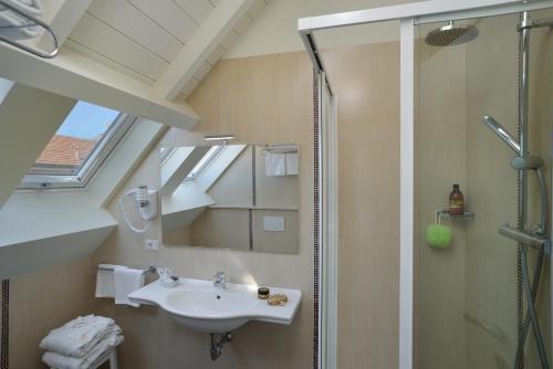 a bathroom with a sink and a shower at Astor Hotel in Bologna