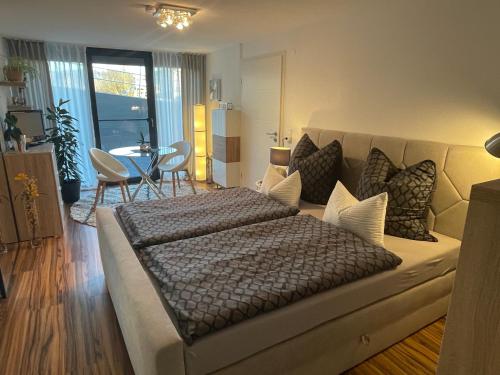 a bedroom with a large bed and a living room at 4-Sterne Ferienwohnung Krill in Bad Wurzach