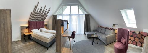 ein Wohnzimmer mit einem Sofa und einem Tisch in der Unterkunft Hotel Mainpromenade ***S in Karlstadt