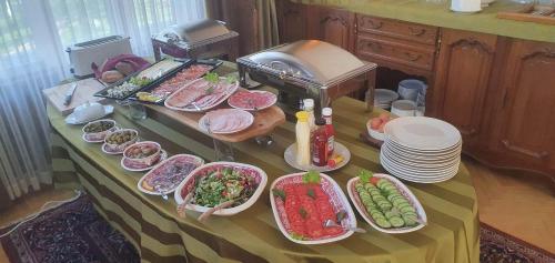 a table with many plates of food on it at Villa Meri in Pärnu