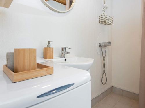 a white bathroom with a sink and a mirror at 6 person holiday home in Hovborg-By Traum in Hovborg